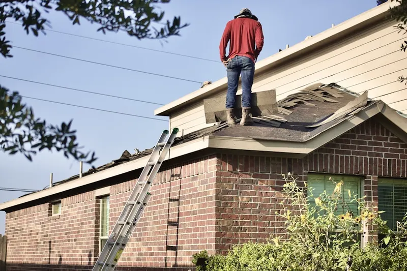 Professional roofer working on a residential roof in Willowbrook
